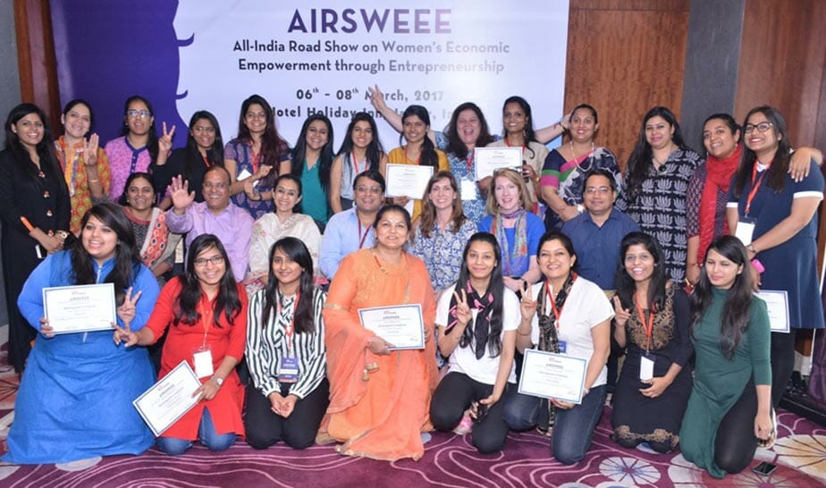 Large group of women posing during an empowerment conference.