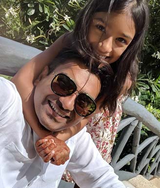 Suchit with his young daughter.
